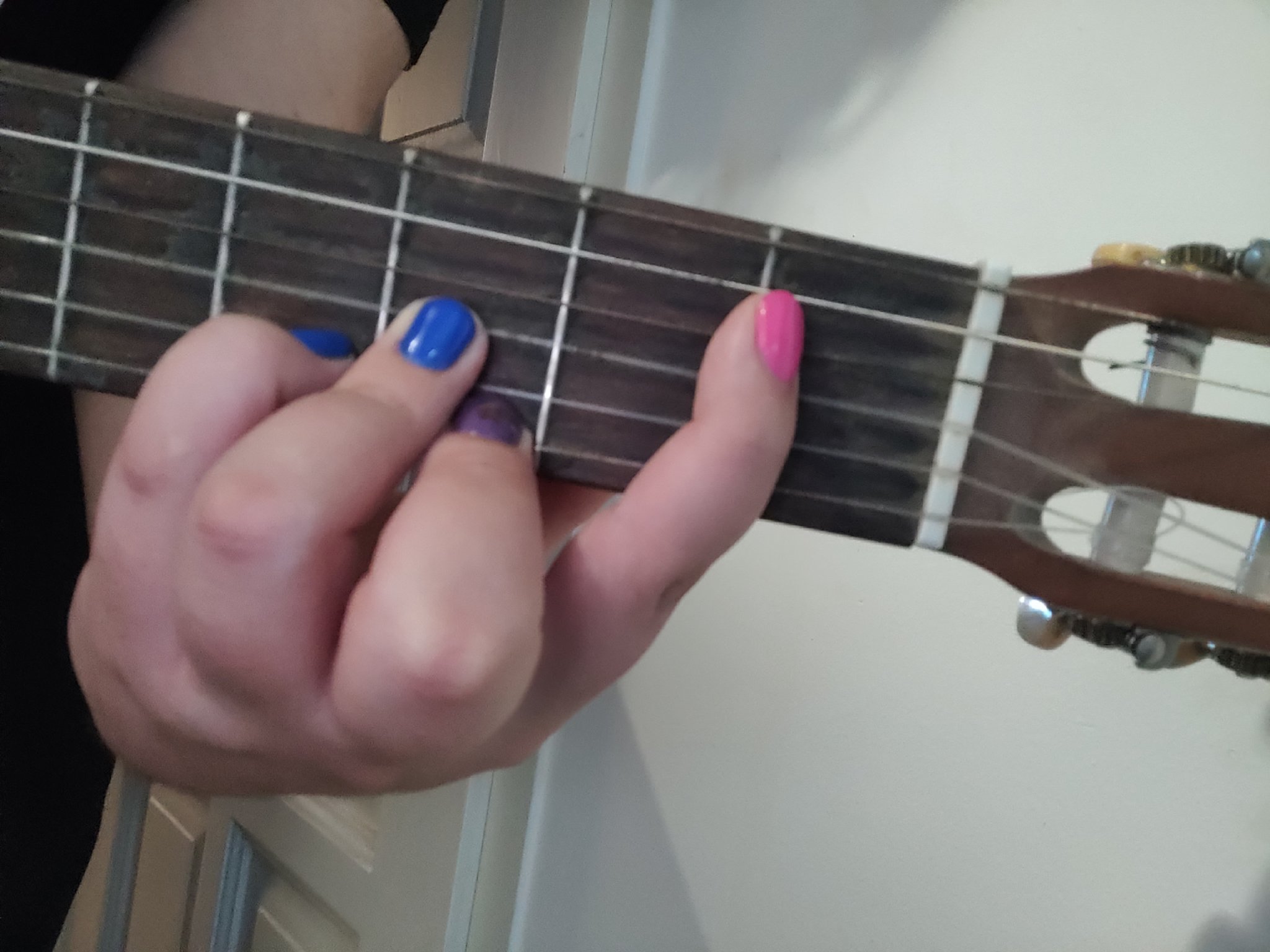 duc holding a D#, also known as a dis (in chord form) on their guitar